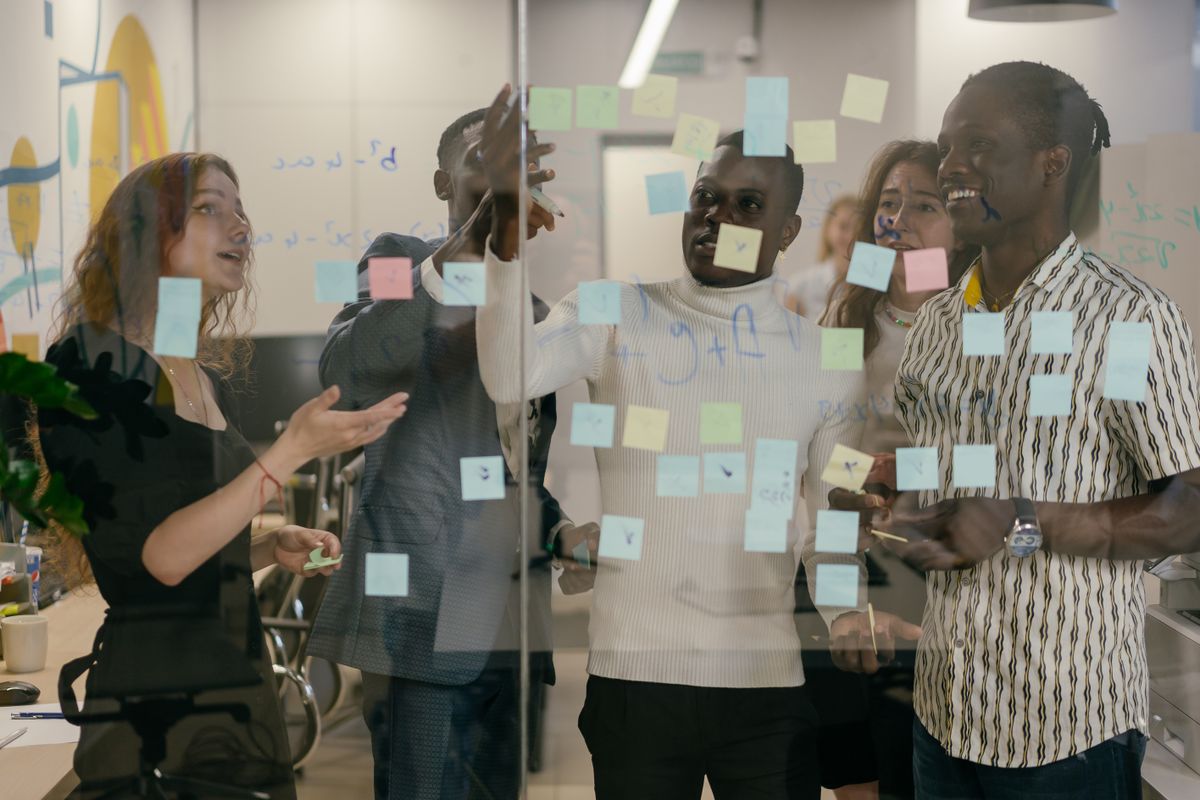 Design team collaborating around a whiteboard