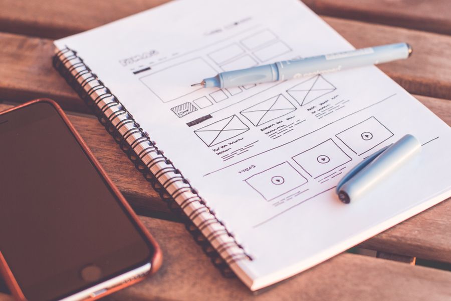 UX/UI wireframes and sketches on a notepad